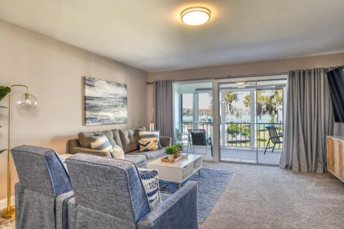 a living room with a couch and chairs and a balcony at River Bend B212 in Welaka