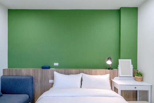 Ένα ή περισσότερα κρεβάτια σε δωμάτιο στο Little House Homestay