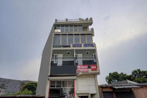 a tall building with a balcony on top of it at OYO Hotel Jmd Residency in Shahdara