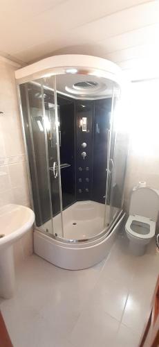 a bathroom with a shower and a toilet at SANCAK HOTEL in Buyukcekmece