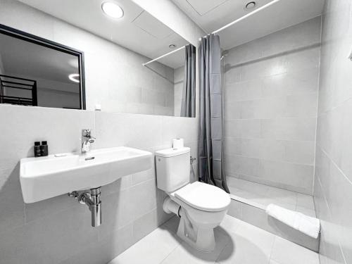 a bathroom with a toilet and a sink and a mirror at Post 120 Suites in Prague