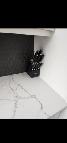 a knife block with knives in it on a wall at Cozy in Regina
