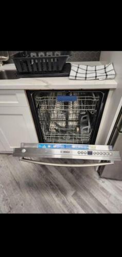 an oven with its door open in a kitchen at Cozy in Regina