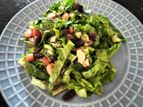 a salad on a plate on a table at Taakradan Valley Resort ท่ากระดานวัลเล่ย์ รีสอร์ท in Si Sawat