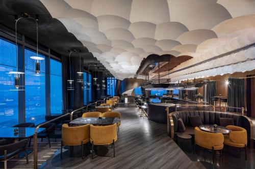a restaurant with a row of tables and chairs at W Suzhou - Jinji Lake in Suzhou