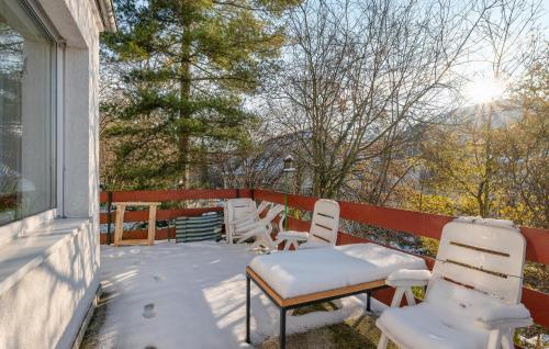 a snow covered porch with chairs and a bench at Lovely Apartment In Jena With Wifi in Jena