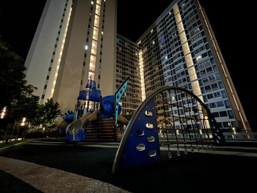 a playground in front of a tall building at C&Y Horizon Suites Homestay Sepang - KLIA Transit - Near XiaMen University in Kampong Melot