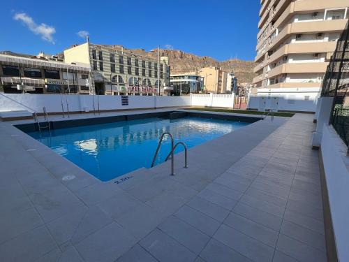 a swimming pool on the roof of a building at PLAYALUZ in Aguadulce