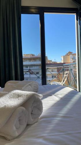 a bed with a towel on it on a balcony at Bed & Business in Drama