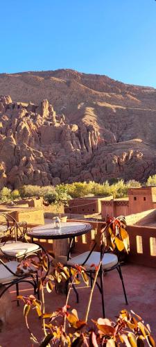 a table and chairs with a view of a mountain at Tafsut dades guesthouse stay with locals in Tamellalt