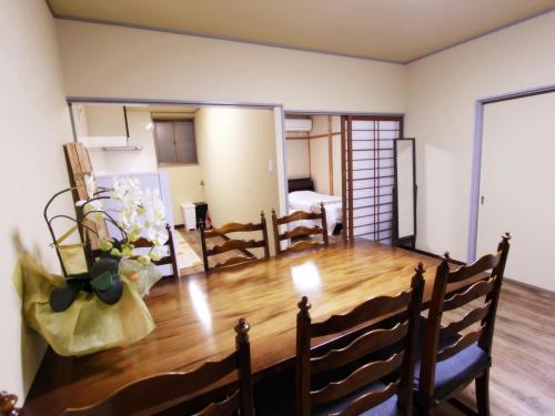 a living room with a wooden table and chairs at 稲荷 かおり in Kyoto