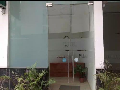 a glass door of a building with plants in it at Hotel Lakshmi Palace in New Delhi