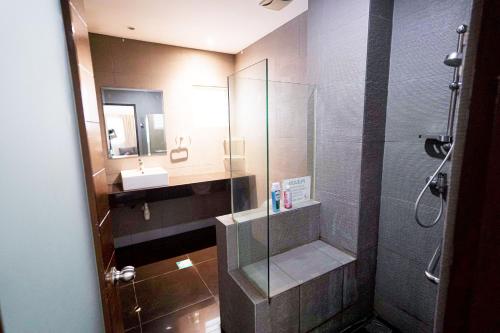 een badkamer met een glazen douche en een wastafel bij AU 27pax Bungalow with Pool Table & Swimming Pool in Kuala Lumpur