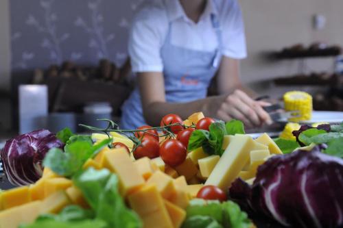 a table topped with lots of cheese and vegetables at Istion Club & Spa in Nea Potidaea