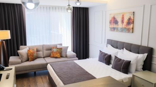 a hotel room with a bed and a couch at MYWAY DELUXE in Konak