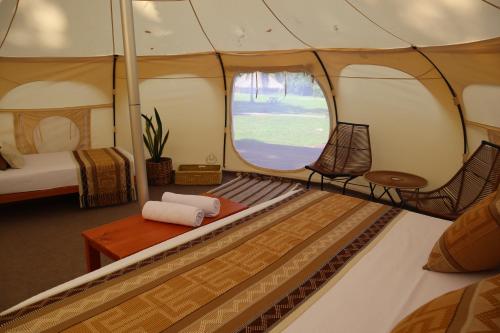 a room with a tent with a table and chairs at Cabañas Tequendama - Parque Tayrona in El Zaino