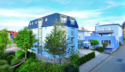 a blue and white building with a blue roof at Lindenberger Hof in Lindenberg im Allgäu