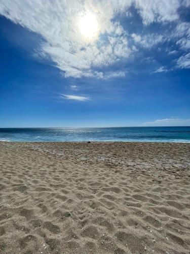 a sandy beach with the ocean in the background at Le Khâlin in Saint-Paul