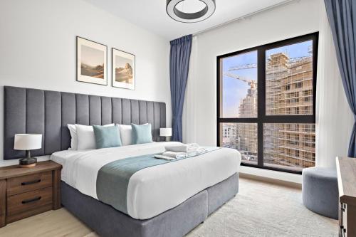 a bedroom with a large bed and a large window at StoneTree - Luxury 1BR - Best Location for Tourist in Dubai