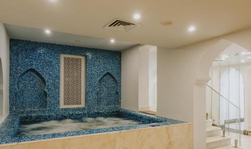 a bath tub in a room with a blue tile wall at Baron Palms Adults Friendly Only 16 years plus Boutique Hotel Style in Sharm El Sheikh