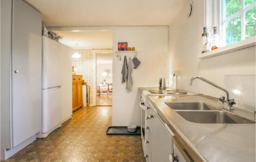 a kitchen with a sink and a refrigerator at 2 Bedroom Beautiful Home In Hr in Höör