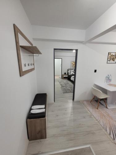 a white bathroom with a sink and a bath tub at Apartament cu 1 camera in Zalău