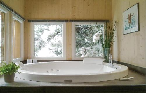 a large white tub in a bathroom with a window at Nice Home In Turrach With 4 Bedrooms And Internet in Turracher Hohe