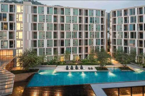 an apartment building with a large swimming pool at Luxury condo in phuket shopping center in Phuket