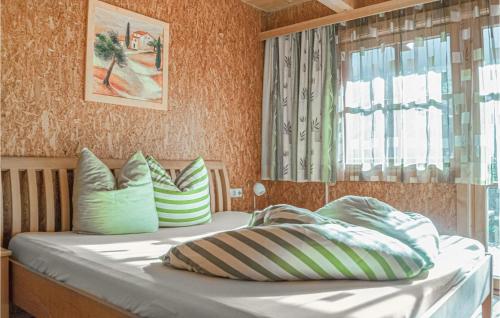 a bed with two pillows on it in a room at Beautiful Home In Mayrhofen With 3 Bedrooms in Mayrhofen