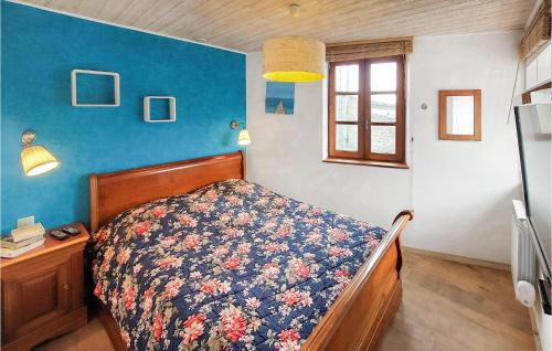 a bedroom with a bed and a blue wall at 1 Bedroom Gorgeous Home In Maclas in Maclas