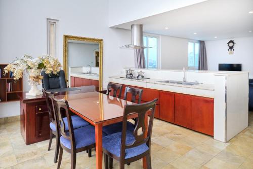a kitchen with a wooden table and chairs and a sink at A25 Hotel - 12 Ngô Sỹ Liên in Hanoi