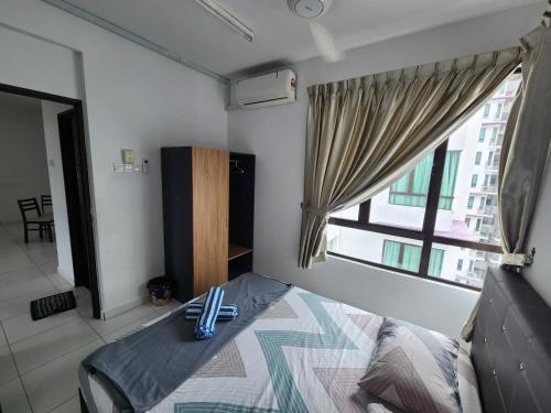 a bedroom with a bed and a window with utensils on it at Pixie Homestay at The Heights Residence Ayer Keroh Melaka in Ayer Keroh