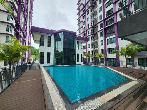 a swimming pool in the middle of a building at Pixie Homestay at The Heights Residence Ayer Keroh Melaka in Ayer Keroh