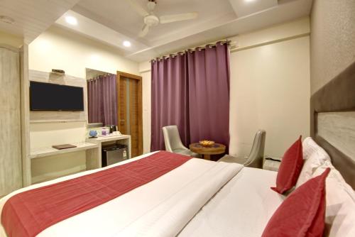 a hotel room with a bed and a desk at The Shanti Plaza - Traveler's choice awarded 2025 in New Delhi