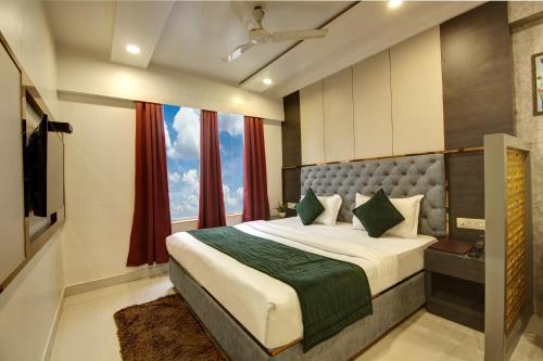 a bedroom with a large bed and a window at The Shanti Plaza - Traveler's choice awarded 2025 in New Delhi