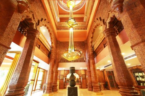 a lobby with two chandeliers in a building at Krishna Beach Resort in Kannur