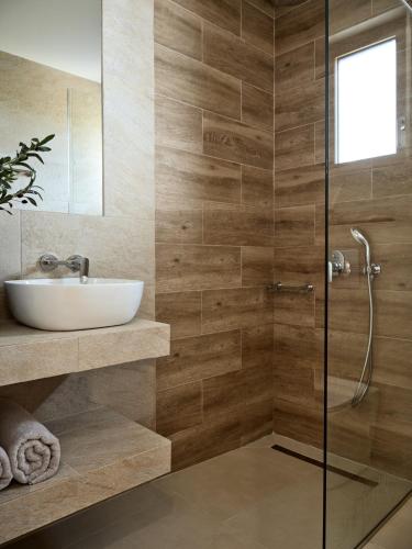 a bathroom with a sink and a shower at Thelxi's Suite I - Brand New Seaview Suite! in Agios Nikolaos