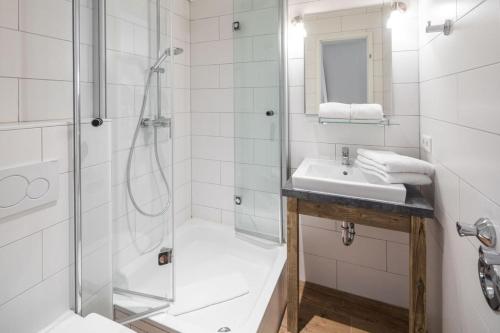 a bathroom with a shower and a sink at Haus Delft Agadir in Juist