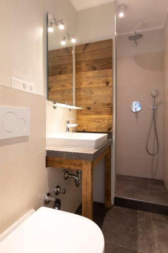 a bathroom with a white sink and a shower at Haus Delft Elisa in Juist