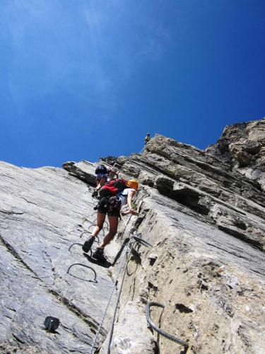 a person is climbing on a rocky mountain at Gite des Sources d'Arvey in Verrens-Arvey