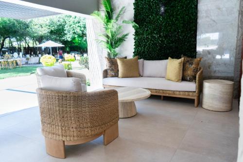 a patio with wicker chairs and a coffee table at Mekete Boutique & Events in Polokwane