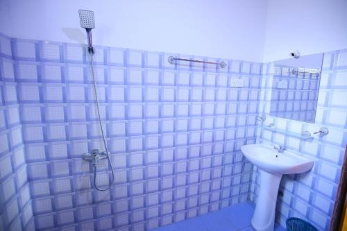 a bathroom with a shower and a sink at Nine Arch View Ella in Ella