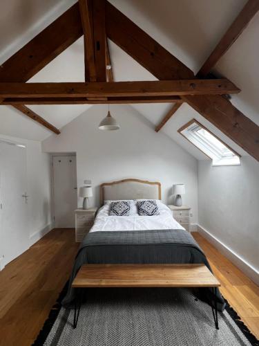 a bedroom with a large bed with a wooden headboard at La Maison Gavraise in Gavray