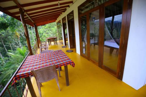 a dining room with a table and chairs on a house at Nine Arch View Ella in Ella
