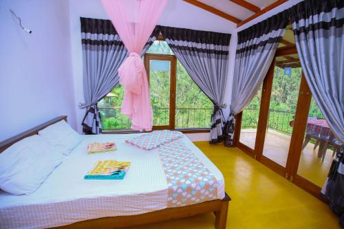 a bedroom with a bed with purple curtains at Nine Arch View Ella in Ella