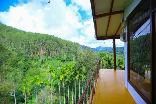 a balcony of a house with a view of a forest at Nine Arch View Ella in Ella