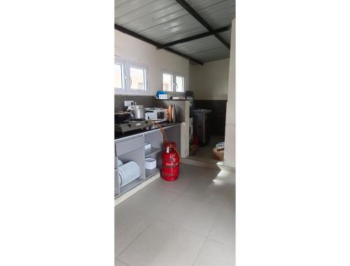 a living room with a red fire hydrant in it at Akkandi Veedu in Kodaikānāl