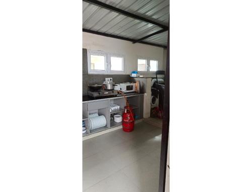 a view of a kitchen from the living room at Akkandi Veedu in Kodaikānāl