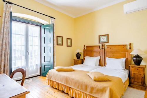 Postel nebo postele na pokoji v ubytování Casa da Arvore
