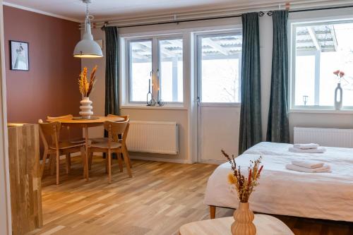 a bedroom with a bed and a table and chairs at Glaskogen Apartments in Glava